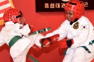 students sparring in children's karate TaeKwonDo martial arts class