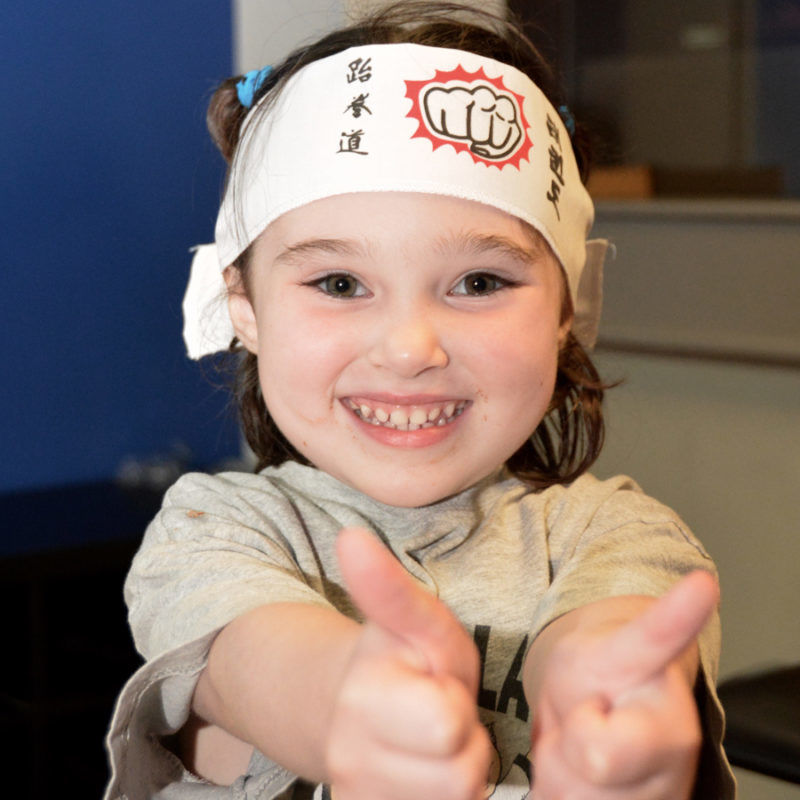 Young girl with thumbs up for KinderKarate